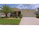 Charming single-story home with a well-manicured lawn and a welcoming front porch at 4858 Magnetite Loop, Mount Dora, FL 32757