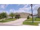 Inviting single-story home with a two car garage and a meticulously maintained front yard at 4858 Magnetite Loop, Mount Dora, FL 32757