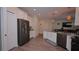 Modern kitchen featuring stainless steel appliances, white cabinets, and sleek countertops at 4858 Magnetite Loop, Mount Dora, FL 32757