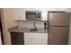 Modern kitchen featuring stainless steel appliances, sleek countertops, and white cabinets, providing a functional and stylish cooking space at 4858 Magnetite Loop, Mount Dora, FL 32757