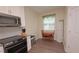 Eat-in kitchen featuring stainless steel appliances, and table with seating for two near a window at 4858 Magnetite Loop, Mount Dora, FL 32757