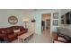 Inviting living room boasts a leather sofa, coffee table, and decorative accents, offering a cozy and stylish gathering space at 4858 Magnetite Loop, Mount Dora, FL 32757