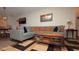 Cozy living room with a large sectional sofa and stylish accent rug at 4858 Magnetite Loop, Mount Dora, FL 32757
