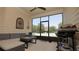 Relaxing screened porch with comfortable seating and outdoor grill, perfect for entertaining guests at 4858 Magnetite Loop, Mount Dora, FL 32757