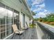 Balcony view features wood decking, gray railings, and outdoor seating perfect for relaxing at 4890 Conway Rd # 66, Orlando, FL 32812