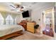 Bedroom with neutral walls, ceiling fan, carpet, light curtains, a dark wood desk and bed at 4890 Conway Rd # 66, Orlando, FL 32812