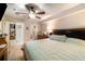 Bedroom with bed, ceiling fan, light walls, carpet, dresser, and adjoining bathroom access at 4890 Conway Rd # 66, Orlando, FL 32812