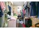 Walk-in closet with built-in shelving, hanging racks, washer, and dryer at 4890 Conway Rd # 66, Orlando, FL 32812