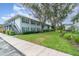 Exterior view of the property featuring landscaping, mature trees, and siding at 4890 Conway Rd # 66, Orlando, FL 32812