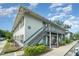 Exterior view of condo with gray staircases and well-maintained landscaping, showcasing a charming and inviting facade at 4890 Conway Rd # 66, Orlando, FL 32812