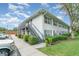 Exterior of the property featuring well-maintained landscaping and a parking area at 4890 Conway Rd # 66, Orlando, FL 32812