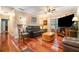 Inviting living room with hardwood floors, plush leather seating, and ample natural light at 4890 Conway Rd # 66, Orlando, FL 32812
