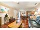 Open-concept living area with hardwood floors that connects the living room, dining area, and kitchen at 4890 Conway Rd # 66, Orlando, FL 32812