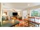 Spacious living area featuring hardwood floors, a dining area, and ample natural light, perfect for modern living at 4890 Conway Rd # 66, Orlando, FL 32812