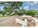 Community outdoor lounge area with tables, benches, and well-maintained landscaping at 4890 Conway Rd # 66, Orlando, FL 32812