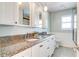 Bathroom featuring granite countertops, dual sinks, and white cabinetry with modern fixtures at 503 Savona Ct, Altamonte Springs, FL 32701