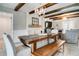 Dining room with exposed beams, modern light fixtures, and a view into the adjacent seating area at 503 Savona Ct, Altamonte Springs, FL 32701