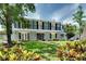 Charming two-story home featuring a lush green lawn and lovely landscaping at 503 Savona Ct, Altamonte Springs, FL 32701