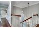 Hallway with dark wood floors, white trim and railings, and modern lighting at 503 Savona Ct, Altamonte Springs, FL 32701