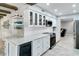 Modern kitchen featuring white cabinets, marble countertops, and stainless steel appliances at 503 Savona Ct, Altamonte Springs, FL 32701