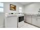 Laundry room featuring modern washer and dryer, granite countertops, and white cabinetry at 503 Savona Ct, Altamonte Springs, FL 32701