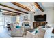 Comfortable living room featuring wood beam accents, a modern fireplace, and neutral tones at 503 Savona Ct, Altamonte Springs, FL 32701