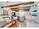 Spacious and open living and dining area with exposed wood beams, fireplace, and modern chandelier at 503 Savona Ct, Altamonte Springs, FL 32701