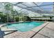 Sparkling screened-in pool surrounded by brick pavers and lush landscaping at 503 Savona Ct, Altamonte Springs, FL 32701