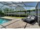 A poolside lounge offers a relaxing view of the backyard's manicured landscaping at 503 Savona Ct, Altamonte Springs, FL 32701