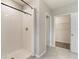 Bright bathroom featuring a walk-in shower with white tiles and a neutral color scheme at 6808 Cranes Roost Rd, Harmony, FL 34773