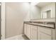 Bathroom vanity featuring double sinks, granite counters, and white cabinets at 6808 Cranes Roost Rd, Harmony, FL 34773