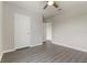 A bright bedroom featuring modern gray floors, white trim, and a ceiling fan for added comfort at 6808 Cranes Roost Rd, Harmony, FL 34773