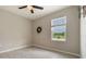 An inviting bedroom with a view of the water, features a ceiling fan and neutral paint scheme at 6808 Cranes Roost Rd, Harmony, FL 34773
