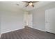 A bright bedroom with gray floors, ceiling fan, and two entry doorways creating an airy ambiance at 6808 Cranes Roost Rd, Harmony, FL 34773