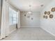 Inviting dining room features tile floors, large windows, and modern lighting at 6808 Cranes Roost Rd, Harmony, FL 34773