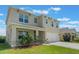 Charming two-story home with a well-maintained lawn, and a two-car garage at 6808 Cranes Roost Rd, Harmony, FL 34773