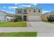 Charming two-story home with a well-maintained lawn, and a two-car garage at 6808 Cranes Roost Rd, Harmony, FL 34773