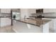 Close-up on kitchen island features granite countertops and stainless steel appliances at 6808 Cranes Roost Rd, Harmony, FL 34773