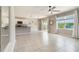 Bright living room features tile floors, ceiling fan, and sliding glass doors to outdoor area at 6808 Cranes Roost Rd, Harmony, FL 34773