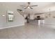 Open-concept living space with lots of natural light, tile flooring, and white kitchen at 6808 Cranes Roost Rd, Harmony, FL 34773