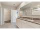 Main bathroom features double sink vanity with granite counters and access to walk-in closet at 6808 Cranes Roost Rd, Harmony, FL 34773