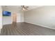 Main bedroom features wood-look floors, ceiling fan, and neutral decor at 6808 Cranes Roost Rd, Harmony, FL 34773