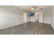 Spacious main bedroom features wood-look floors, ceiling fan, and television at 6808 Cranes Roost Rd, Harmony, FL 34773