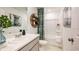 Bright bathroom with a white vanity, a shower-tub combination and neutral wall decor at 7807 Waterscape Dr, Groveland, FL 34736