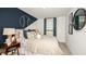Nicely appointed bedroom featuring baseball-themed decor and a comfortable bed with stylish linens at 7807 Waterscape Dr, Groveland, FL 34736