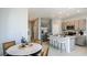 Open concept design with kitchen, dining area, and living room with sleek finishings at 7807 Waterscape Dr, Groveland, FL 34736