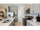 Modern kitchen with stainless steel appliances, gray cabinets, and a large island at 7807 Waterscape Dr, Groveland, FL 34736