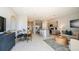 Open concept design with kitchen, dining area, and living room with plenty of natural light at 7807 Waterscape Dr, Groveland, FL 34736