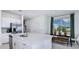 Stylish kitchen with island, stainless steel appliances, and dining area at 7811 Waterscape Dr, Groveland, FL 34736