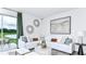 Bright living room featuring a plush white sectional sofa, stylish decor, and a view of the outdoors at 7811 Waterscape Dr, Groveland, FL 34736
